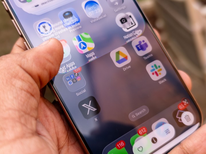 iPhone 16 Pro displaying the new Liquid Glass design in iOS 26 beta, showcasing translucent notification center.